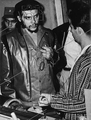 Che Guevara (Ernesto Rafael Guevara, 1928-1967), révolutionnaire cubain d’origine argentine et ministre de l'Industrie, visitant la fabrique de textiles Griguanabo Baula, son appareil respiratoire à la main. Ariguanabo (Cuba), 1959.