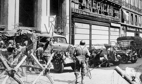 World War II. Liberation of Paris. Capture of the Kommandantur. Street battle and German soldier with a white flag. August 1944.