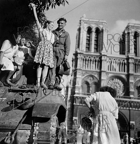 World War II. Liberation of Paris on August 25, 1944, 7a.m. in front of Notre Dame de Paris Cathedral. On the tank, Michel Frys, who was later wounded by an ambushed German soldier.