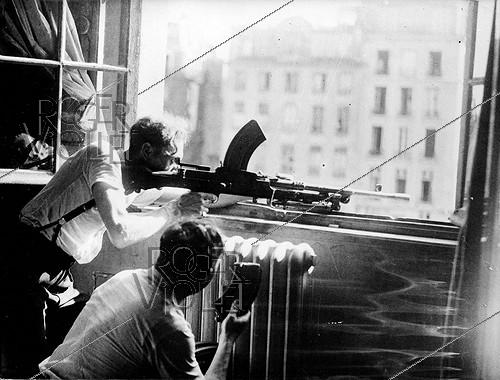 World War II. Liberation of Paris. Resistance fighters of the F.F.I. (French Forces of the Interior) at the window of the police headquarters, on August 25, 1944.